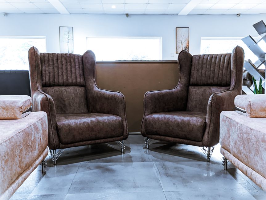 Stylish brown leather armchairs in a modern lounge interior, perfect for relaxation and comfort.